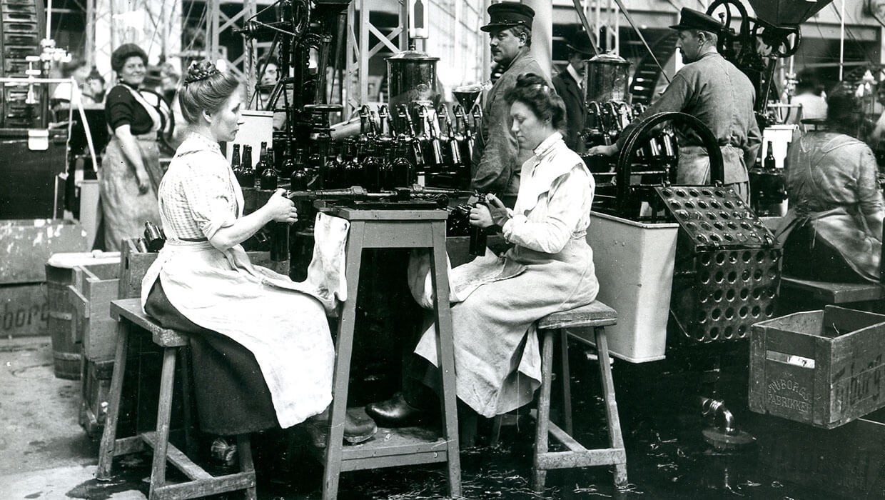 Woman working in Turbogs brewery at an assembly line to ensure beer bottle quality
